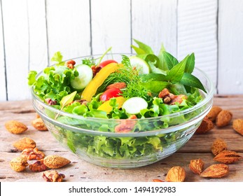 Vegan Salad With Almond Nuts In A Glass Bowl On A Rustic Wooden Table For Vegetarian Food Or Light Meal Concept.