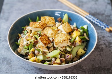 Vegan salad with crispy tofu, red and wild rice and mango - Powered by Shutterstock