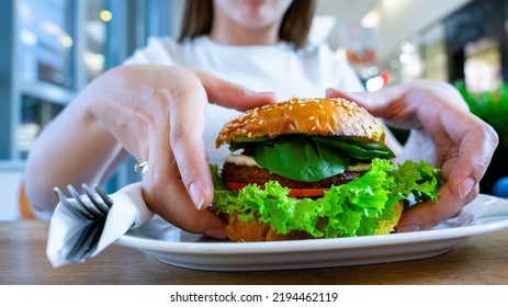 Vegan Sandwich Healthy Vegetarian Burger. Cute Cheerful Girl Eating Veggie Hamburger With Salad, Avocado, Vegetable. Vegetarian Diet Food Concept