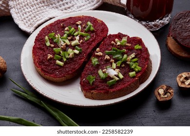 Vegan sandwiches with beetroot spread, young onion, garlic and walnut. Seasonal organic food close up. Vitamin B, P, PP. - Shutterstock ID 2258582239
