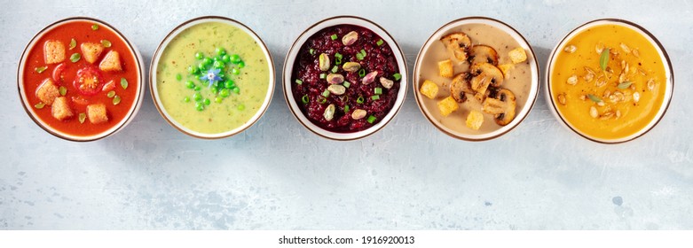Vegan soup panoramic banner with a place for text. Many vegetable cream soups, shot from above