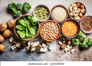 Vegan Sources Of Protein Background, Top View. Tofu, Chickpeas, Lentils, Nuts, Spinach And Broccoli Are Vegetable Proteins.