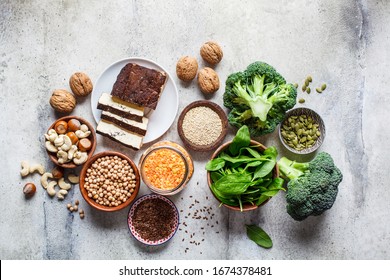 Vegan Sources Of Protein Background, Top View. Tofu, Chickpeas, Lentils, Nuts, Spinach And Broccoli Are Vegetable Proteins.