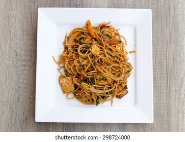 Vegan spaghetti with tofu and pepper delicious from above on wood desk - Shutterstock ID 298724000