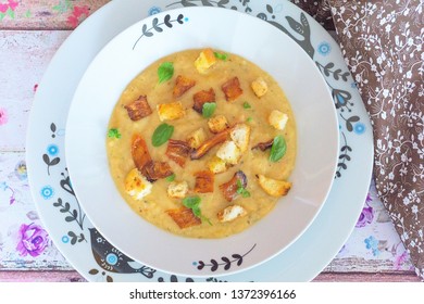 Vegan split-pea soup (London particular) with smoked carrot vegetarian bacon, croutons and fresh marjoram leaves - Shutterstock ID 1372396166