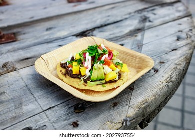 Vegan taco with avocado, mango and tomatoes served fresh