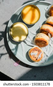 Vegan Tofu Cheese Pancakes On Blue Plate, Gray Concrete Table. Direct Sun Light, Focus On Shadows. Food Blog Photography Concept. Overhead