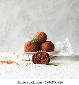 Vegan truffle. Chocolate Potato Cake on white paper on a light background with space for text.
