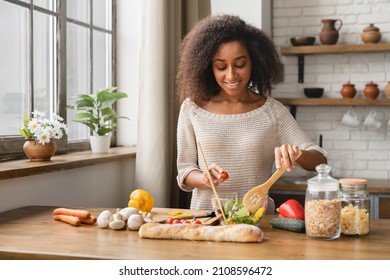 Vegan Vegetarian Food Meal Concept. Dieting And Healthy Eating Habits. African Woman Girl Cooking Vegetable Salad At Home Kitchen