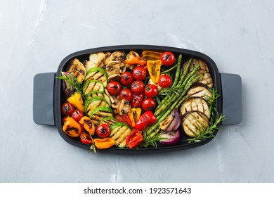 Vegan, vegetarian, seasonal, summer eating concept. Grilled vegetables in a pan on a table. Top view flat lay background - Powered by Shutterstock