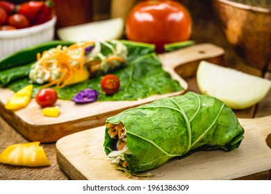 vegan wrap made with kale or lettuce leaf, stuffed with various vegetables, healthy fast food - Powered by Shutterstock