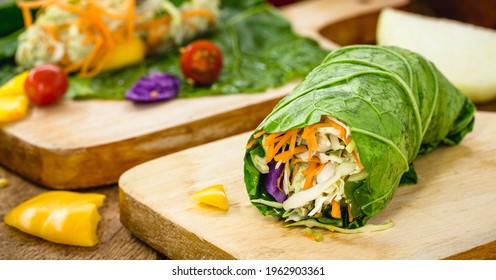 vegan wrap made with kale or lettuce leaf, stuffed with various vegetables, healthy fast food - Powered by Shutterstock