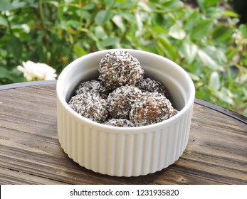 Vegan/Plant Based Chocolate And Coconut Bliss Balls Photographed Outdoors