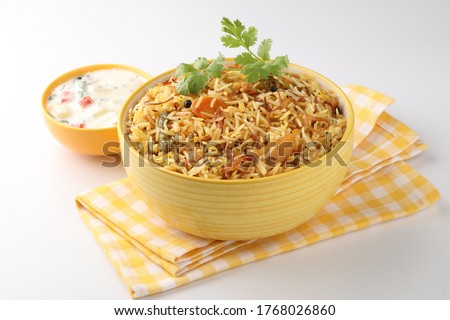 Vegetable Biryani a flavorful Indian rice dish with peas, carrots and potatoes with spicy spices. selective focus