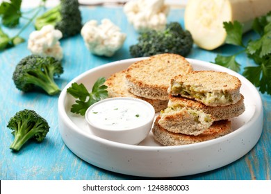 vegetable cutlets and sauce in a white bowl, cauliflower, broccoli on a wooden background - Powered by Shutterstock