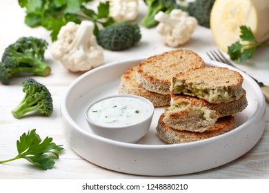 vegetable cutlets and sauce in a white bowl, cauliflower, broccoli on a wooden background - Powered by Shutterstock