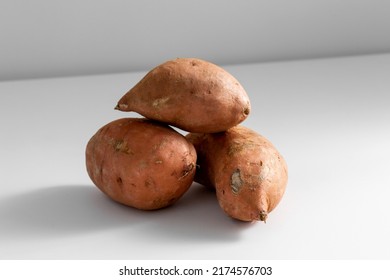 vegetable, food and culinary concept - close up of sweet potatoes on table