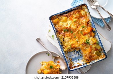 Vegetable gratin with sweet potato, celery, parsnip, carrot, cheese and eggs. Comfort, rustic one casserole foods