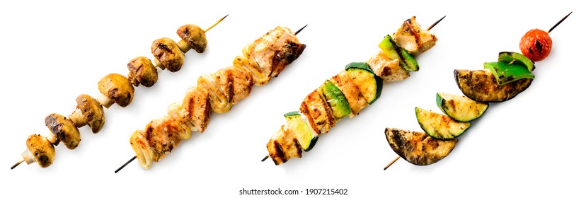 Vegetable kebabs with peppers, mushrooms, zucchini, onions, tomatoes. grilled BBQ on skewers isolated on a white background for the menu - Shutterstock ID 1907215402