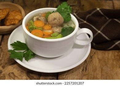 vegetable and meatball soup with tempeh side dish on old wooden background - Shutterstock ID 2257201207