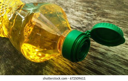 Vegetable Oil in Plastic Bottle on Wooden Background
