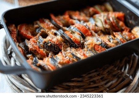 Vegetable ratatouille in a rectangular casserole of cast iron. Traditional french provencal vegetable stew. Healthy vegetarian nutrition. Close-up with short depth of field.