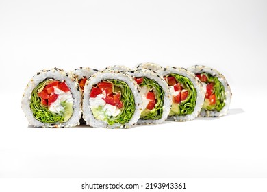 Vegetable roll with feta cheese. Roll stuffed with lettuce, feta cheese, tomatoes and avocado. The filling is wrapped in nori seaweed, rice and topped with white and black sesame seeds. Sushi stands o - Powered by Shutterstock