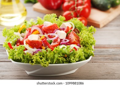 Vegetable salad in bowl on wooden table - Shutterstock ID 1099881086