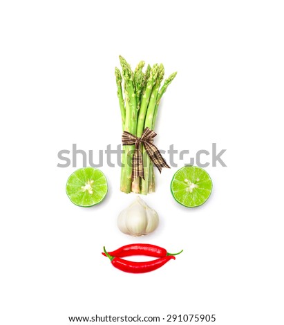 vegetable smiling face from red chili pepper , garlic , asparagus and lime on white background