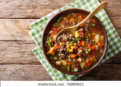 Vegetable Soup With Ground Beef Close-up In A Bowl On The Table. Horizontal Top View From Above
