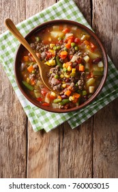 Vegetable Soup With Ground Beef Close-up In A Bowl On The Table. Vertical Top View From Above
