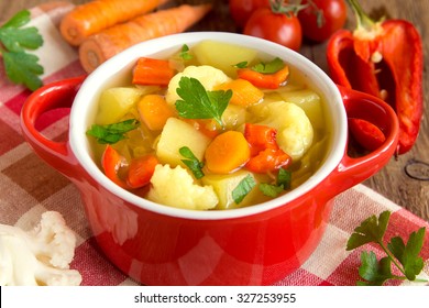 Vegetable soup with ingredients carrot cauliflower potato parsley pepper cabbage tomato close up
