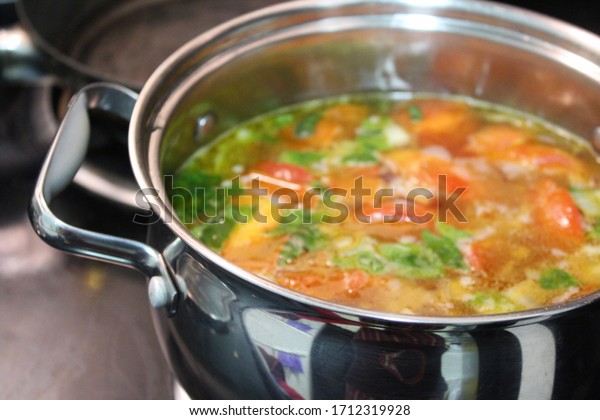Vegetable soup simmering in a\
pot
