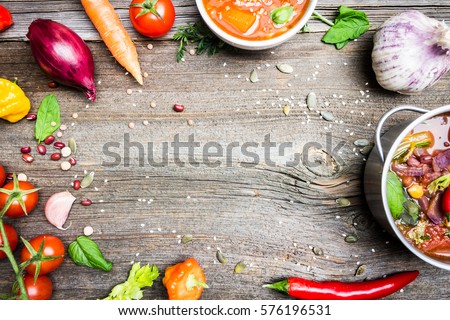 Vegetable Soups and Cooking Ingredients. Empty Space in the Middle of Wooden Table Background