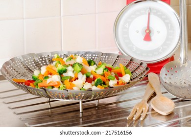 Vegetable Steamer With Vegetables MIX INSIDE AND BALANCE OVER DRAINING BOARD