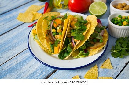 vegetable tacos on blue wooden surface