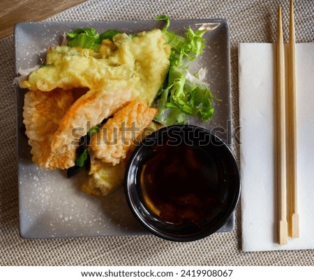 Vegetables in batter with with soy sauce on ceramic plate. Japanese cuisine