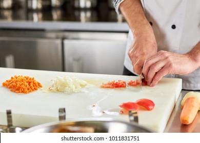 Vegetables chopping, piles of chopped vegetables. Red bell pepper chopping, chopped bell pepper. Vegetables dicing. - Powered by Shutterstock