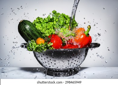 Vegetables In A Colander Under Running Water