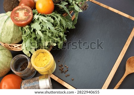 Vegetables dark background with copy space. Healthy meal. Menu, price background. Vegetables on black chalkboard.