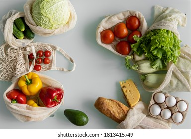 Vegetables, fruits, eggs in reusable eco cotton bags on table. Zero waste shopping concept. Plastic free items. Multi-use, reuse, recycle. Eco friendly canvas grocery bag with tomatoes, pepper, bread. - Powered by Shutterstock