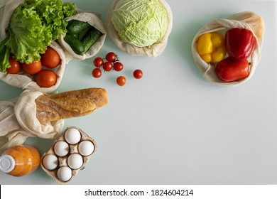 Vegetables, fruits, eggs in reusable eco cotton bags on table. Zero waste shopping concept. Plastic free items. Multi-use, reuse, recycle. Eco friendly canvas grocery bag with tomatoes, pepper, bread. - Powered by Shutterstock