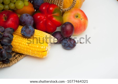 Vegetables and Fruits in Rustic Basket Isolated on White. Healthy Food.