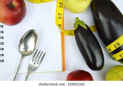 Vegetables And Fruits For Weight Loss, A Measuring Tape, Diet,measuring Tape, Healthy Eating, Healthy Lifestyle Concept.Notepad,diary,eggplant,Apple,pear