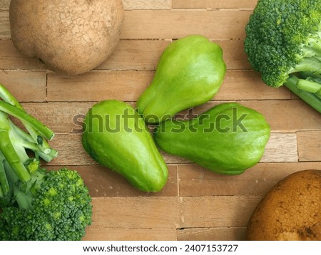 Vegetables green chayote, full of nutrition such as vitamin and viber, and broccoli and potatoes as a background