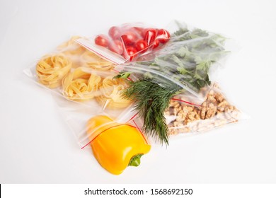Vegetables, greens and nuts packing in zip lock on a white background - Shutterstock ID 1568692150