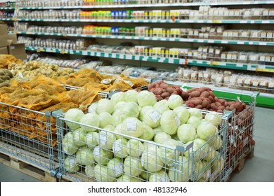 Vegetables and groceries in supermarket, focus is on cabbages