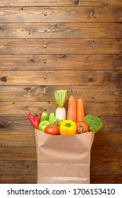 Vegetables In Grocery Bag On Wood Background