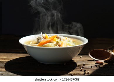 Vegetables And Ground Pork, I Steaming. A Bowl Of Hot Food On Wood Table On Black Background. Hot Food Concept