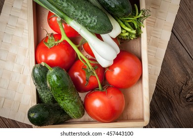 Vegetables from the home garden in a wooden box. Selective focus.